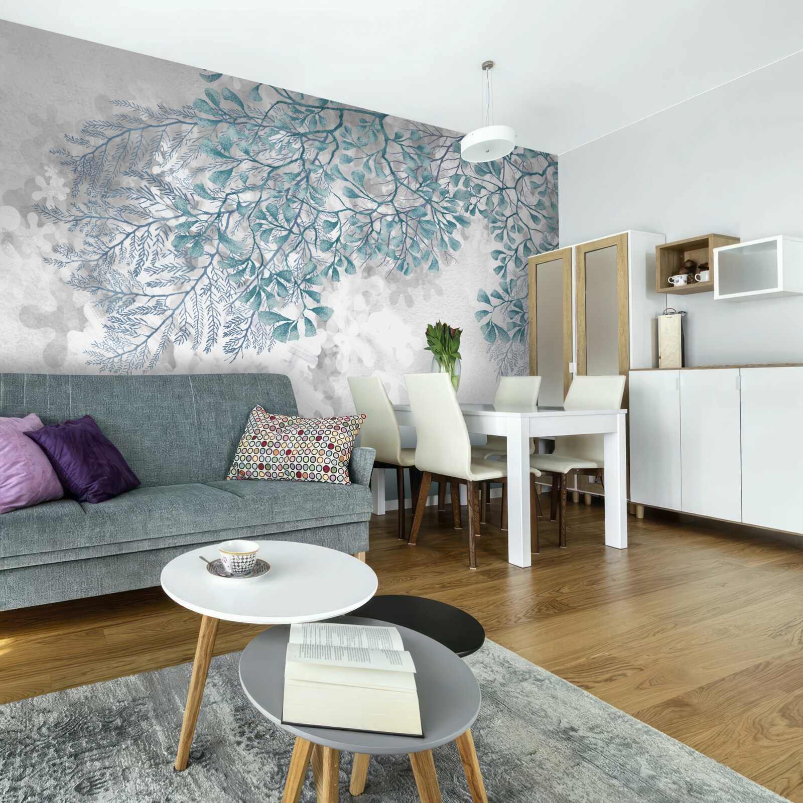 Fototapeta na jasnym tle widoczne są gałęzie z turkusowymi liśćmi