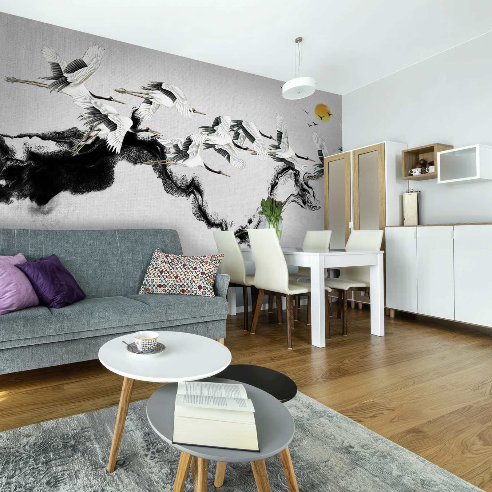 Fototapeta grupa żurawi z japonii szybuje w stronę zachodu słońca