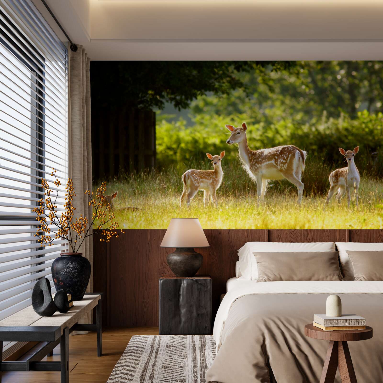 Fototapeta na polu pasie się grupa jeleni z cętkowaną sierścią