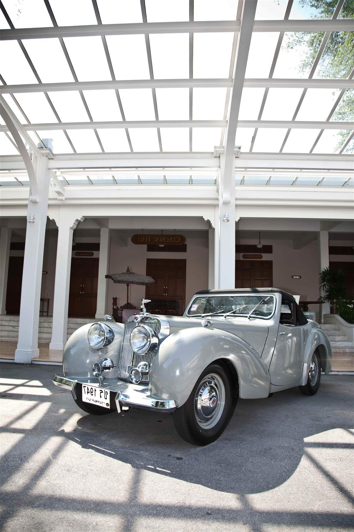 Fototapeta stary szary samochód w pobliżu budynku