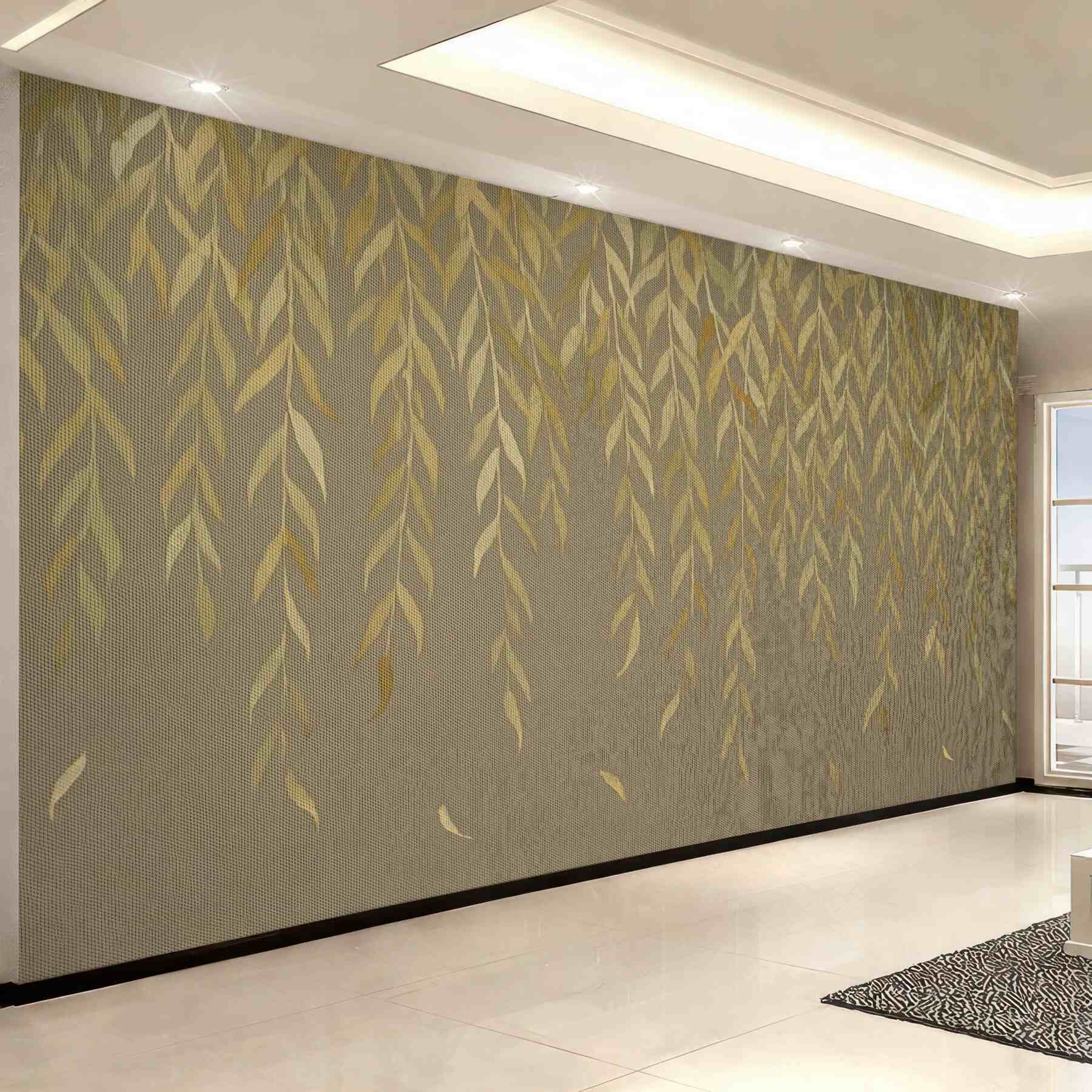 Fototapeta Gałęzie wierzby z liśćmi w odcieniach żółci i zieleni opadające na brązowym płóciennym tle.