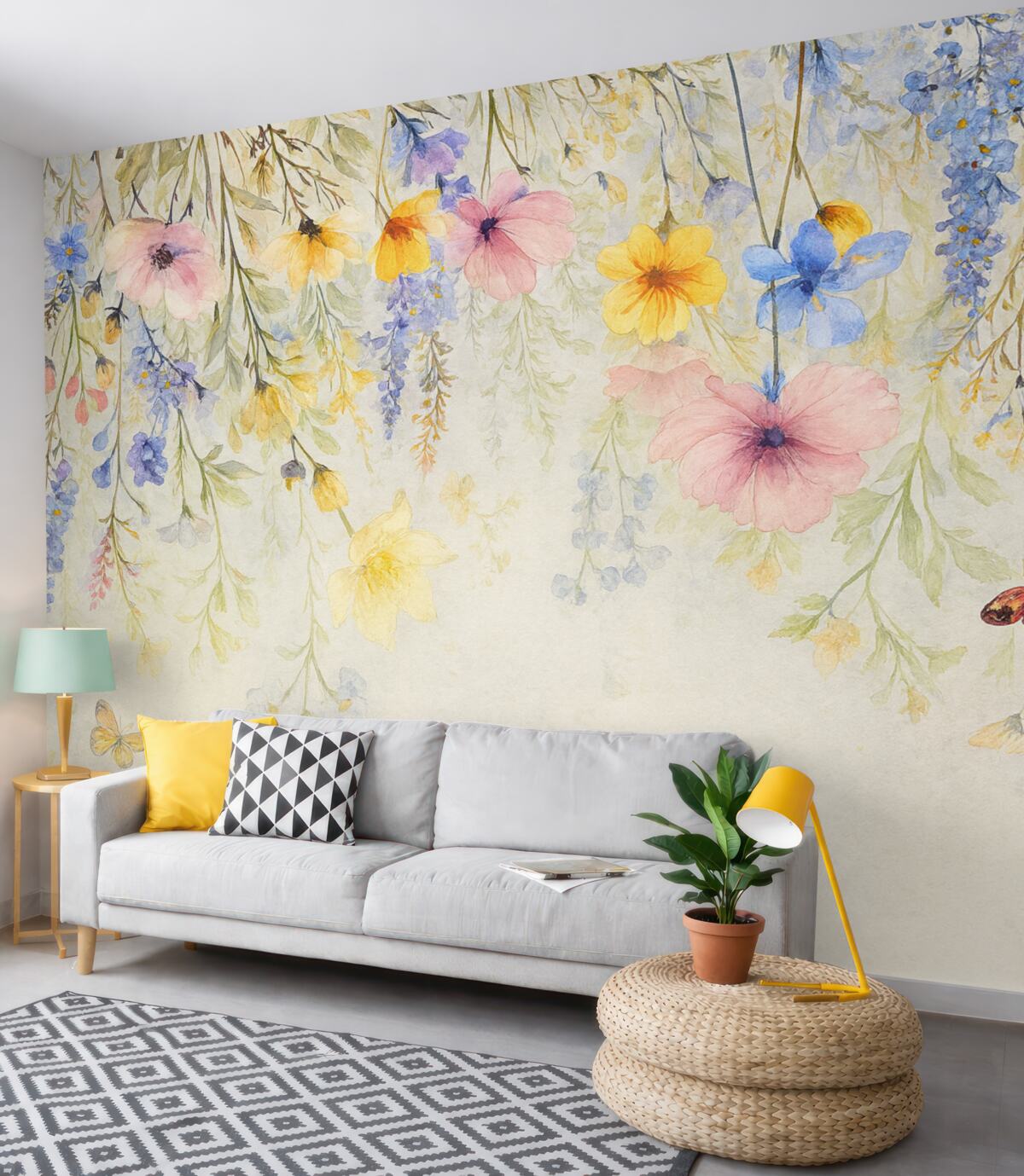 Fototapeta Kolorowe kwiaty o różowych, żółtych i niebieskich płatkach zwisające z góry na fakturowanym szarym tle.