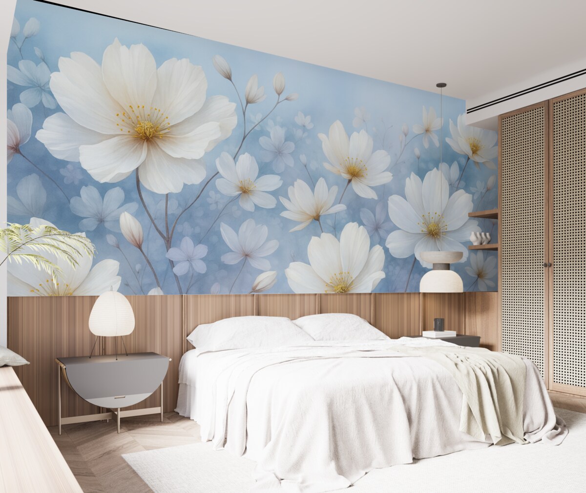 Fototapeta Subtelne białe kwiaty z gładkimi płatkami na rozmytym niebieskim tle, kreujące radosną i lekką atmosferę.